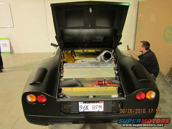 Black sports car rear view, engine compartment open, license plate 96K RPM