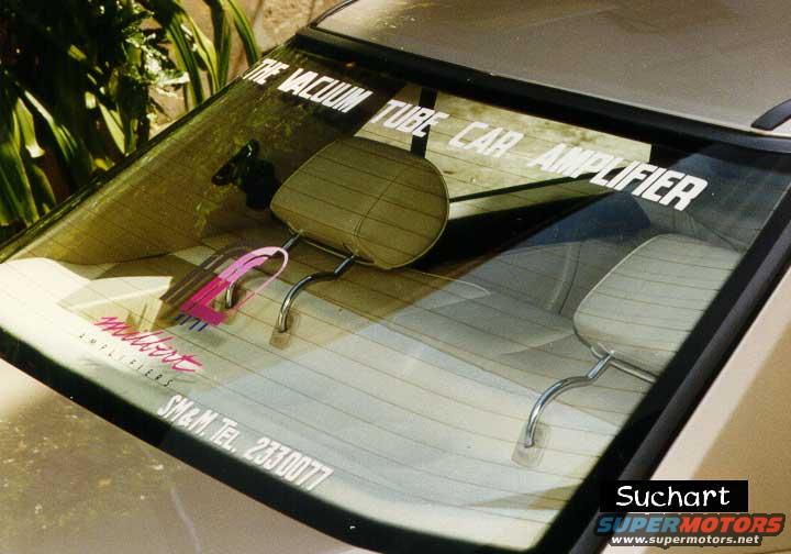 Rear window with stickers reading "THE VACUUM TUBE CAR AMPLIFIER" and "SM&M TEL. 2330077"
