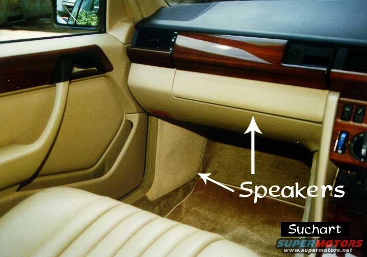 Interior view of a 1986 Mercedes-Benz E-Class showing the dashboard, door panel, and speakers