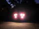 1988 Ford Bronco - Vehicle with bright headlights illuminated at night in a driveway.