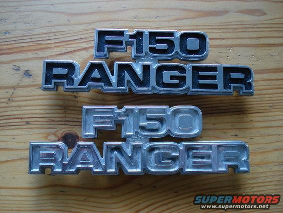 Two sets of Ford F-150 Ranger emblems on a wooden surface