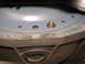 1994 Ford Bronco - A close-up view shows a bolt on a gray metal surface with several holes, with the Supermotors.net logo in the corner.