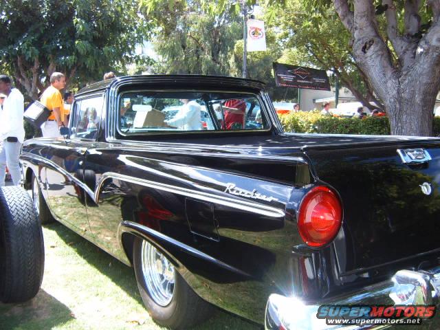 1956 Ford Fairlane pickup truck, rear quarter view, black paint, chrome trim, custom wheels