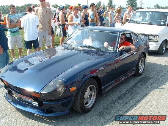Blue 1977 Datsun 280Z coupe with aftermarket front spoiler and alloy wheels