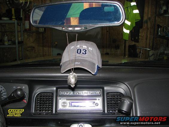 Ford Crown Victoria interior with a gray Ford 03 hat hanging from the rearview mirror