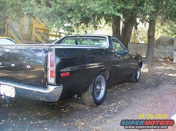 Black 1972 Ford Ranchero, rear view, chrome bumper, aftermarket wheels, parked outdoors