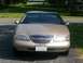 1997 Lincoln Mark VIII - Front view of a tan 1997 Lincoln Mark VIII, identifiable by its distinctive grille and headlights.