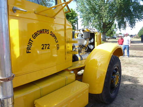 Yellow truck with "FRUIT GROWERS SUPPLY CO. 272" on the side, engine visible, parked outside