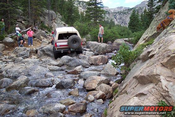 Steve climbing out of French's Creek with some difficulty.  notice me in the beige shirt woundering how my bronco is going to go up it.