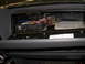 1988 Ford Bronco - Interior view of a vehicle's fuse box and wiring harness, with a spare fuse container.