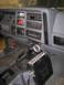 1988 Ford Bronco - The interior of a Jeep Cherokee shows the dashboard, center console, and a CB radio mounted below the dash.