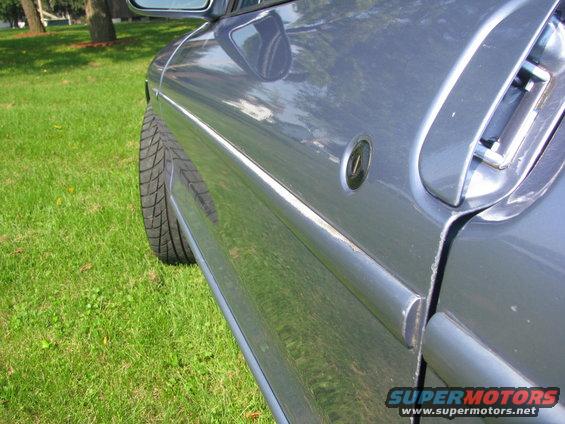 1994 Ford Probe side door and tire on grass