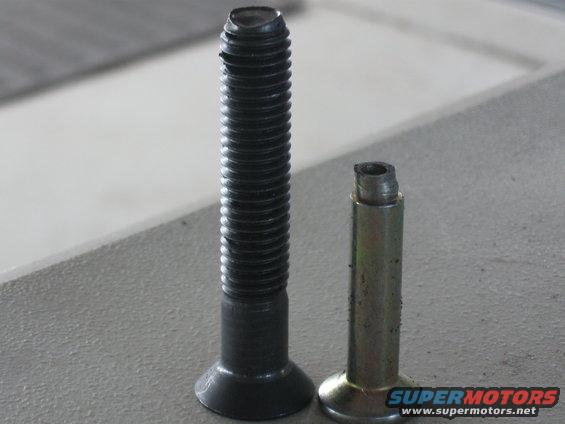two bolts side-by-side, one is intact and threaded, the other is shorter and broken off at the top
