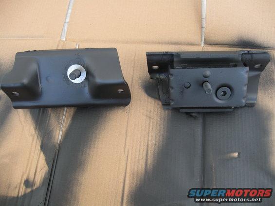 Two black motor mounts on a cardboard surface