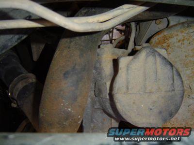 Steering gear box with hoses and rusty metal components