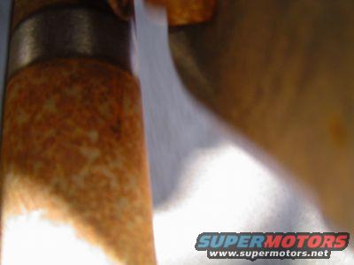 close-up of rusty steering gear box part with SUPERMOTORS.NET watermark