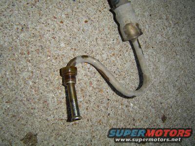Power steering hose with metal fittings on concrete