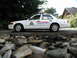 2001 Audi A4 - A model of a white RCMP police car is shown from the side, with a tree and house in the background.