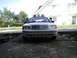 2001 Audi A4 - A police car with a light bar is parked on a concrete surface in front of a house.