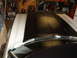 1973 Ford Ranchero - The hood of a 1973 Ford Ranchero shows a black vinyl top with white racing stripes, viewed from above.
