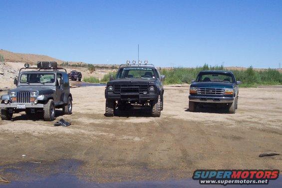 Jeep Wrangler, Ford F-150, and Ford Bronco parked on dirt
