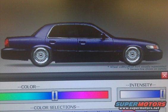 Dark blue sedan with custom wheels, possibly a Mercury Grand Marquis, shown on a computer screen with color selection tools