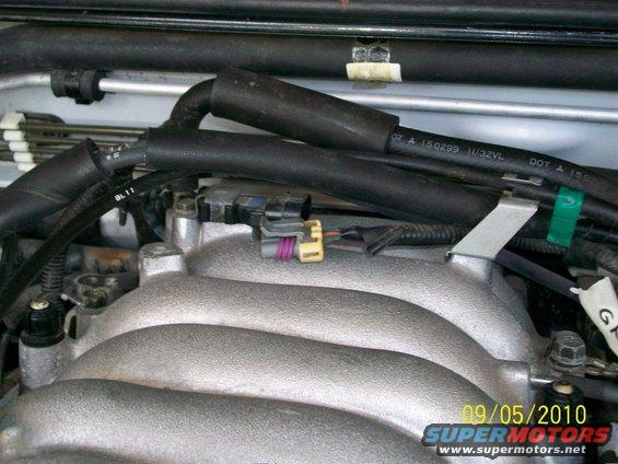 close-up of engine intake manifold with hoses and connectors