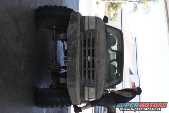 Mud-covered 1992 Ford Bronco front view, lifted with large tires