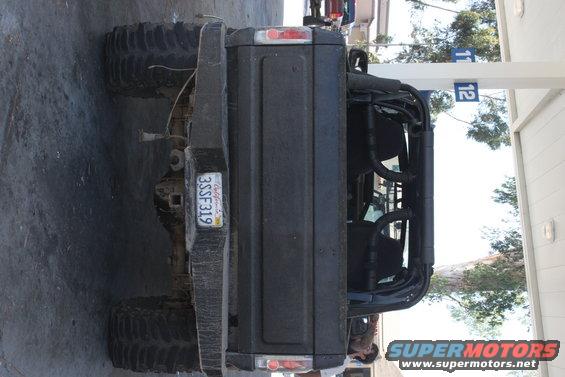 Black SUV rear view with roll cage and California license plate 3SSF319