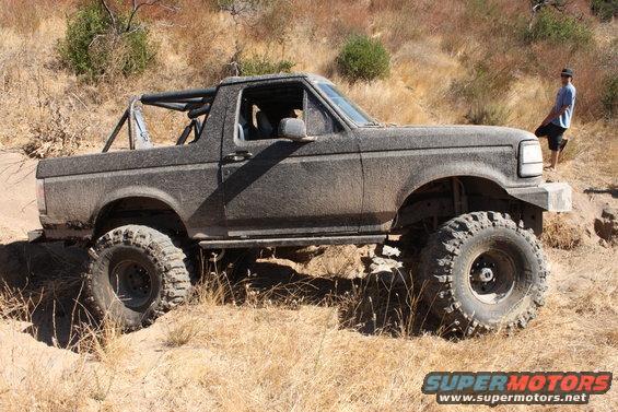 1992 Ford Bronco with off-road modifications on a dirt trail