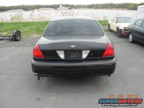 Black 2000 Ford Crown Victoria rear view. Other vehicles visible