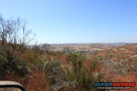Dry, hilly landscape under a clear blue sky