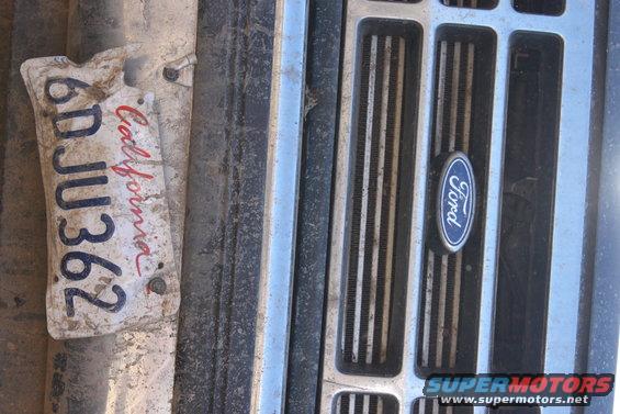 Dirty California license plate 6DJU362 attached to a weathered Ford grille
