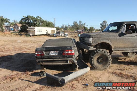 1992 Ford Bronco crushing a sedan, front 3/4 view