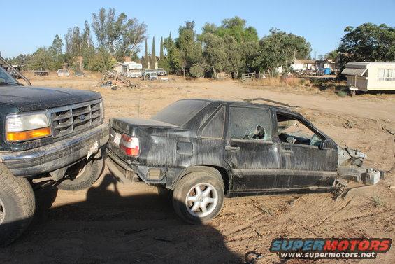 Ford F-Series truck front end bumper close to a wrecked black sedan