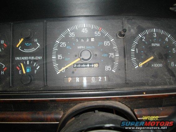 1990 Ford Bronco dashboard with speedometer, tachometer, fuel, and oil gauges. Odometer shows 71183.1 miles