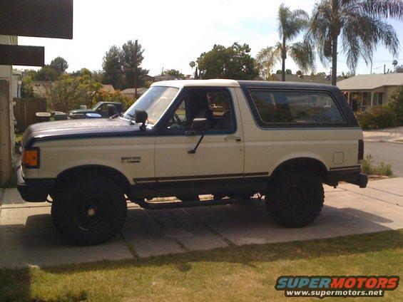 1989 Ford Bronco parked on a driveway, side view