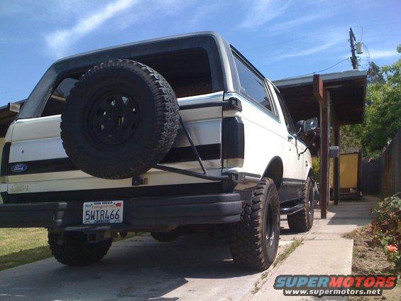 White Ford Bronco with a rear-mounted spare tire and California license plate 5WTR466