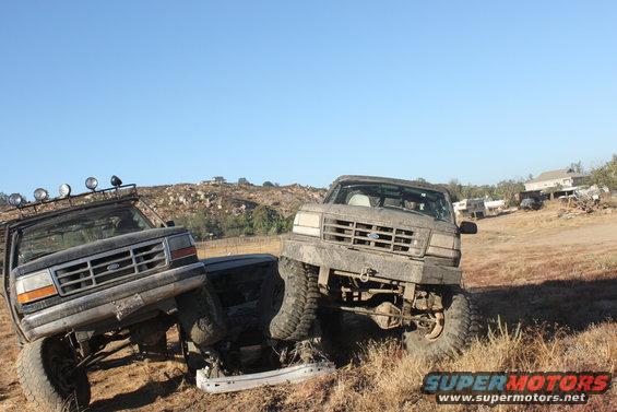1992 Ford Bronco and another Ford truck off-road, front 3/4 view