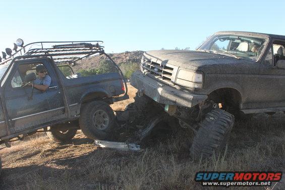1992 Ford Bronco and another truck stuck together off-road