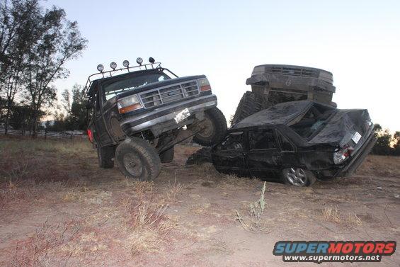 1992 Ford Bronco front grille, lifted, on crushed car