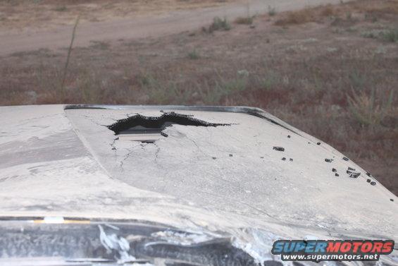Damaged roof of a vehicle with a large hole