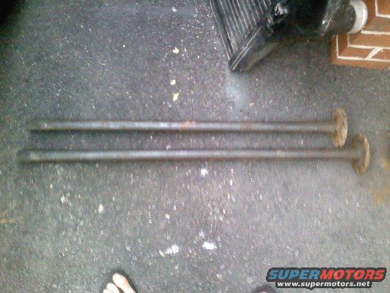 Two metal shafts with flanges on concrete