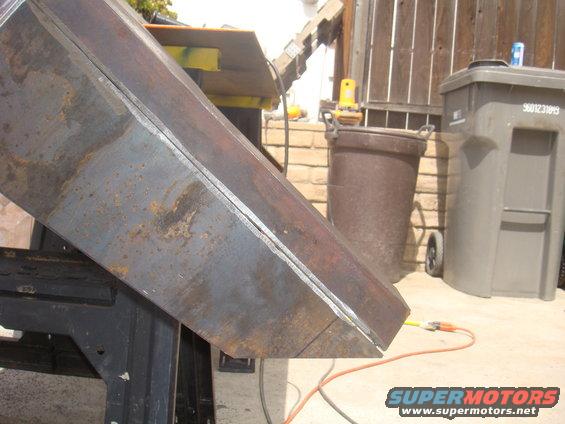 Metal fabrication part with visible weld lines and rust