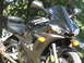 2008 Yamaha R1 - A black Yamaha R6 motorcycle is shown from the front, parked in a grassy area with trees in the background.