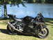 2008 Yamaha R1 - A black Yamaha motorcycle is parked on the grass next to a body of water on a sunny day.