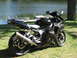 2008 Yamaha R1 - A black Yamaha R6 motorcycle is parked on the grass next to a body of water.