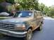 1992 Ford Bronco - This 1992 Ford Bronco is heavily covered in mud, suggesting recent off-roading activity.