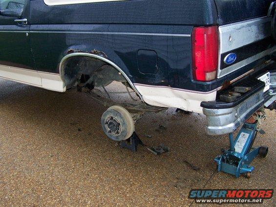 1992 Ford Bronco rear side with missing wheel, jacked up