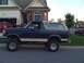 1992 Ford Bronco - This lifted Ford Bronco is parked on a suburban street in front of a residential home.
